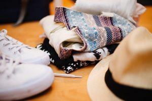 Some clothes, a hat and white trainers. 