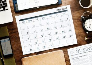 A calendar on the table. Starting your search a couple of months before the moving date is the best way to find affordable movers in Toronto. 