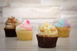 There are four cupcakes on the picture, all with different frosting.