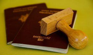 Two passports on a green surface, needed when moving to Toronto from Europe.