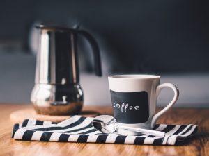 A mug and a pot of coffee. 