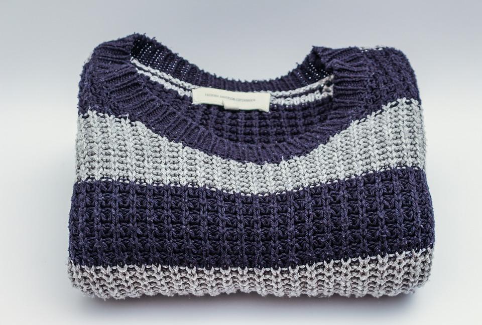 A neatly folded sweater, which is a great way to save space while packing clothes.