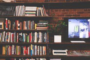 A bookshelf and a flat screen TV. Moving heavy weight items such as these is hard.