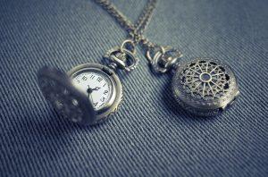 Two antique-looking pocket watches. 