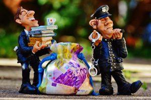 Two figurines of a police officer and a businessman.