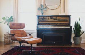 An antique piano in a living room.