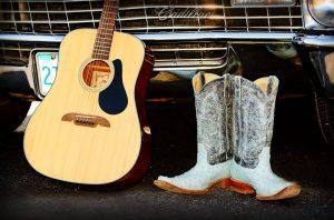 A guitar and cowboy boots. 