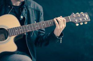 A man playing a guitar in one of the live music venues in Toronto.