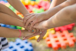 Friends holding hands.