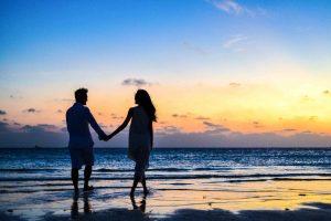 A couple on a beach in one of the best suburbs in Toronto