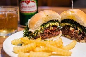 Beer and burger with french fries on a table