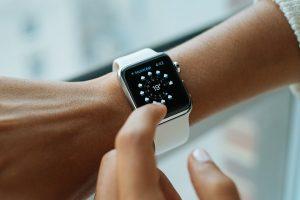 A white smartwatch on a wrist.