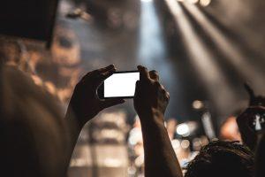 A person taking a picture in one of live music venues in Toronto.