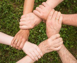 People with their hands intertwined. 